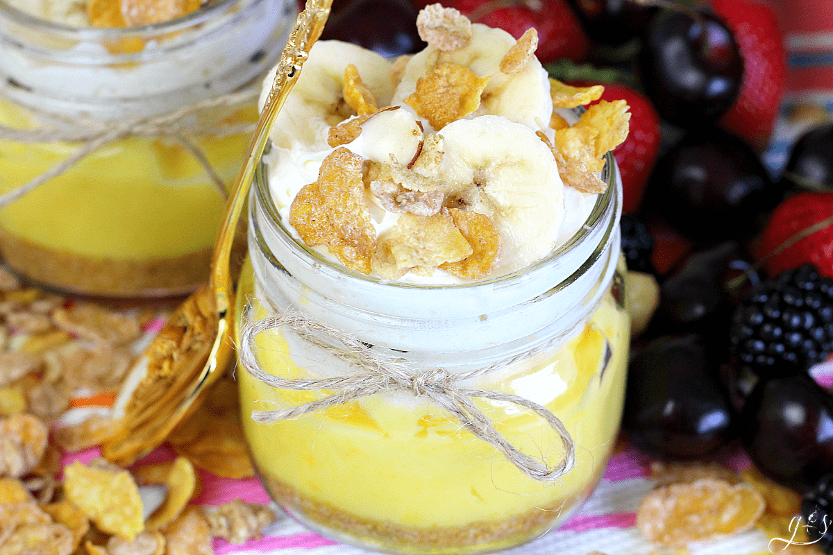 Up close photo of a French Vanilla Pie in a Jar using an 8 oz mason jar tied with twine and topped with cereal.