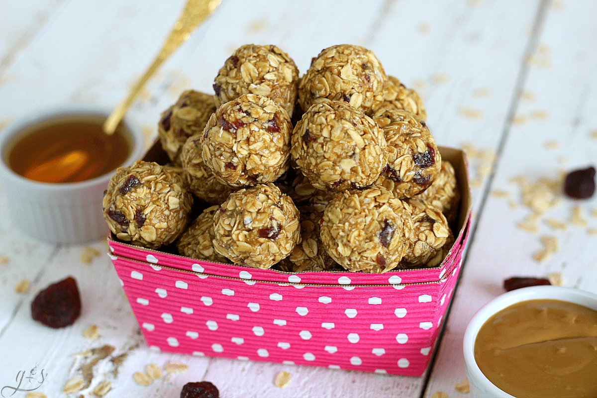 Sunbutter and Jelly energy bites recipe stacked high in a pink polka dotted paper dish