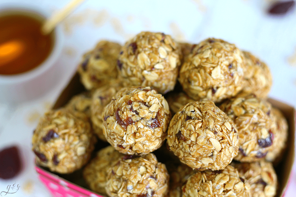 Up close shot of an energy bite recipe that is nut free and only uses four ingredients- oatmeal, Sunbutter, honey, and dried strawberries. 