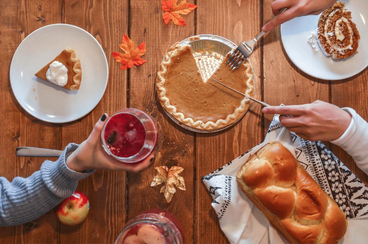 Family get together with pie and bread and cranberry drinks.