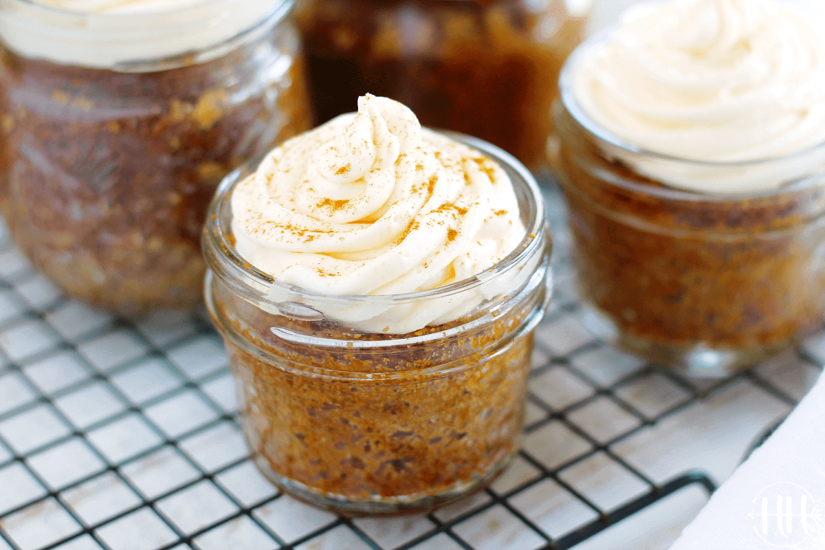 Small mason jar full of carrot cake and frosting. 