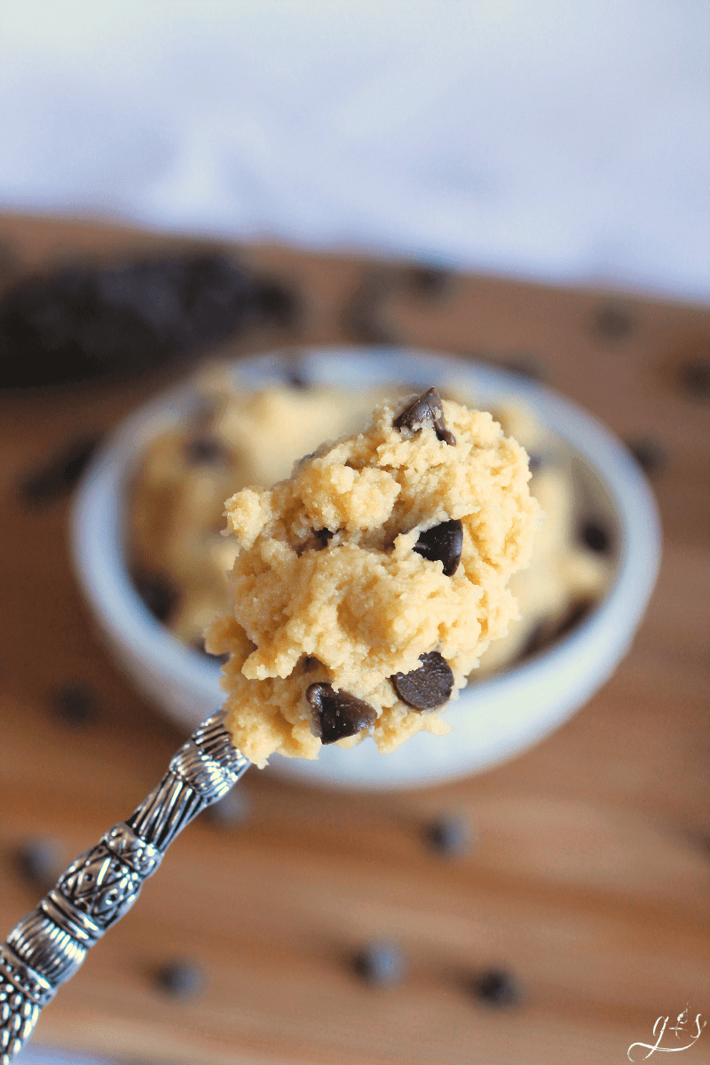 Yummy spoonful of edible cookie dough scattered with chocolate chips. 