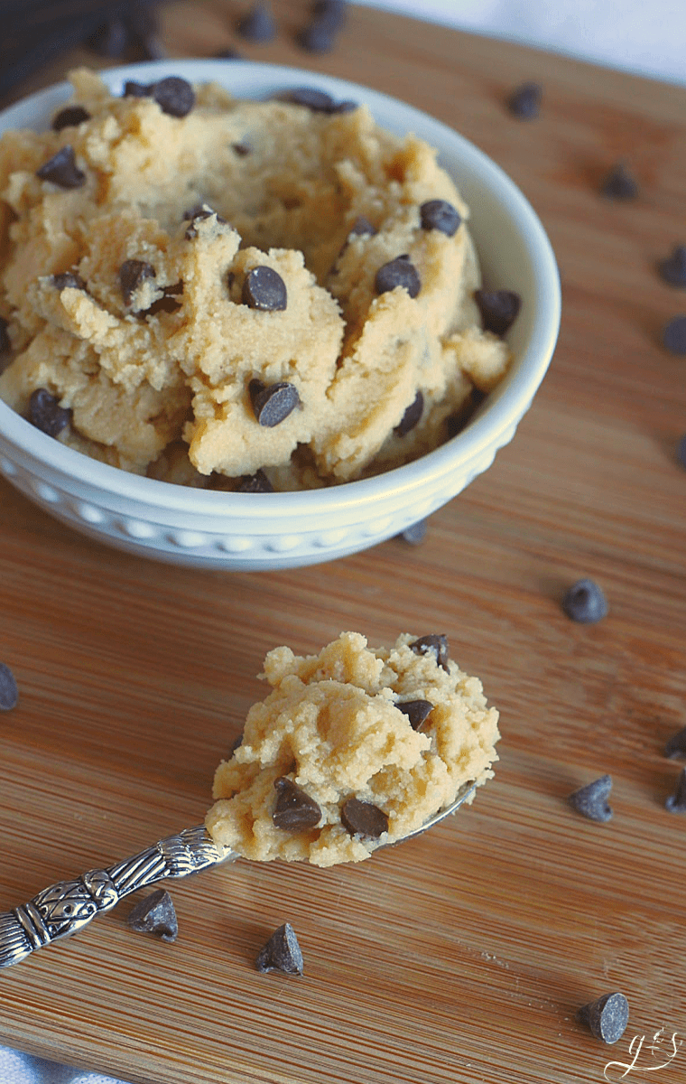 A small spoon with chocolate chip cookie dough on it.