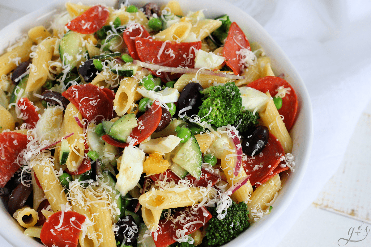 A beautiful bowl of cold gluten free pasta salad loaded with veggies, pepperoni, and hard boiled eggs. 