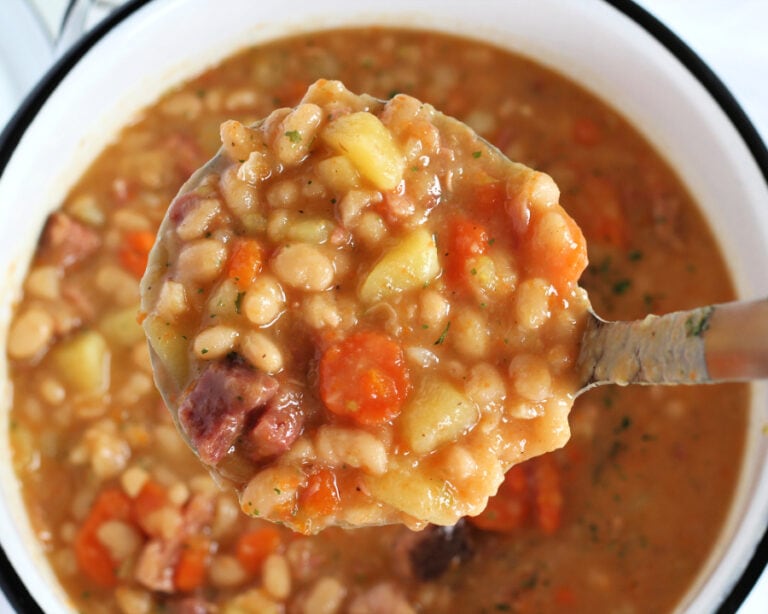 Up close overhead photo of a ladle of Instant Pot Ham and Bean Soup.