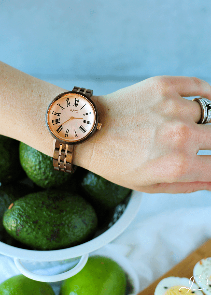 A woman's wrist adorned with a Vintage Rose and Walnut JORD watch. 