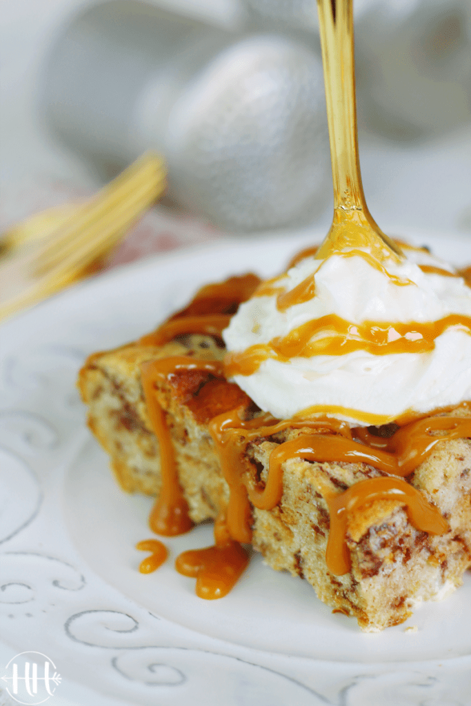 Pretty slice of bread pudding with whipped cream.