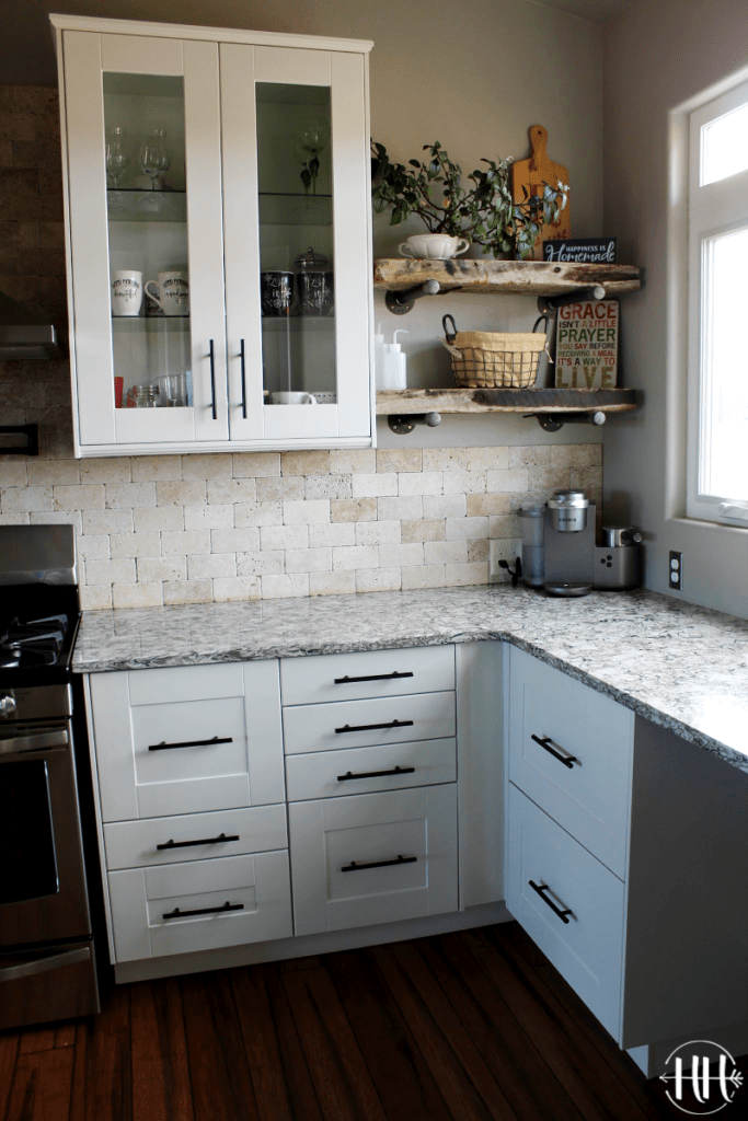 Tall wall white cabinets with rustic plant shelves and Bellingham Cambria Quartz counter top.