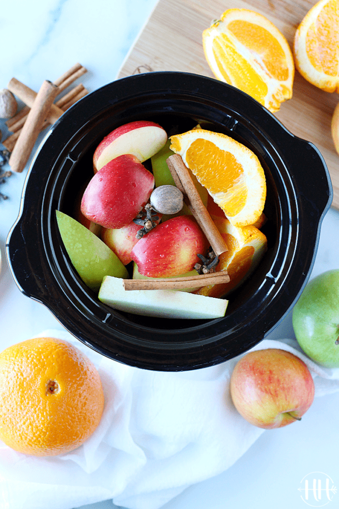 The BEST Crockpot Apple Cider | This easy homemade recipe is packed full of sweet apples, oranges (cuties), cinnamon sticks, nutmeg, cloves, and maple syrup. Serve this small batch of a classic hot drink on those cold fall nights or on Thanksgiving. Use your small slow cooker (1.5 qt) or triple the recipe and use your regular appliance. This simple from scratch recipe is healthy too using only natural sugar not brown sugar. #easyrecipes #fallrecipes #glutenfree #healthyrecipes #cleaneating