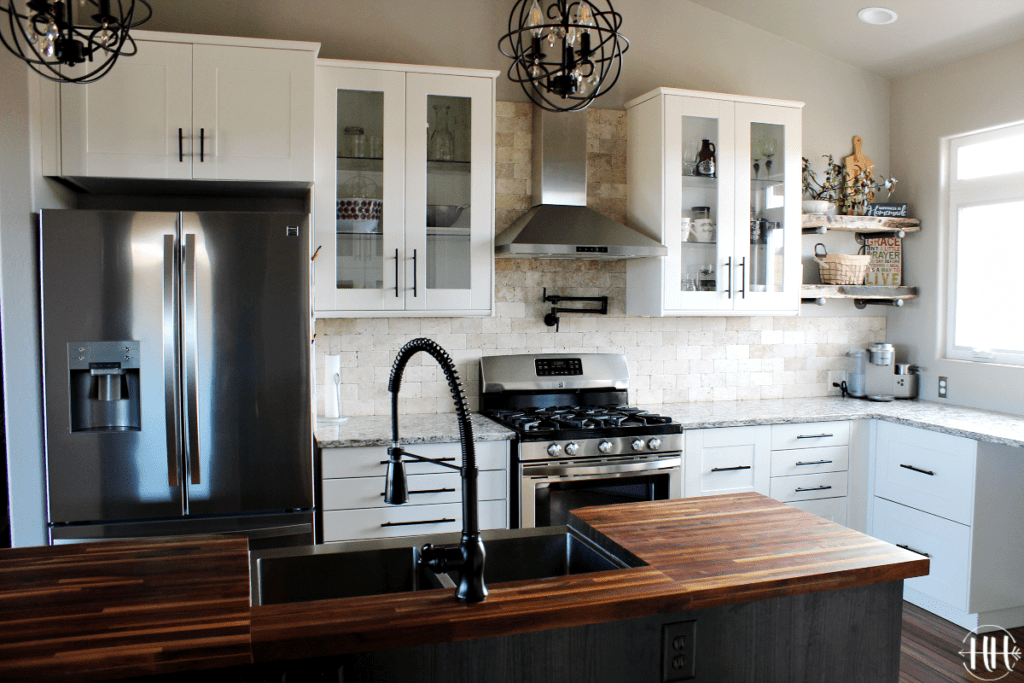 Completed IKEA kitchen with SEKTION cabinets, TINGSRYD island with sink, stainless steel hood and appliances.