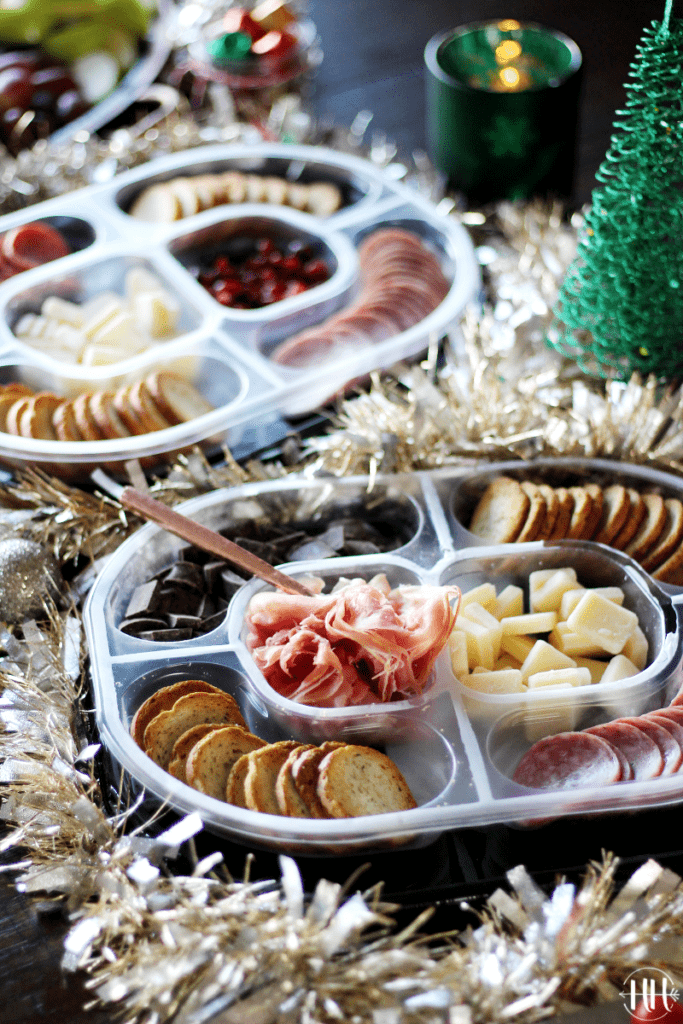 Hillshire Snacking Social Platters: Genoa Salame & Prosciutto with Christmas garland around it for a holiday grazing table.