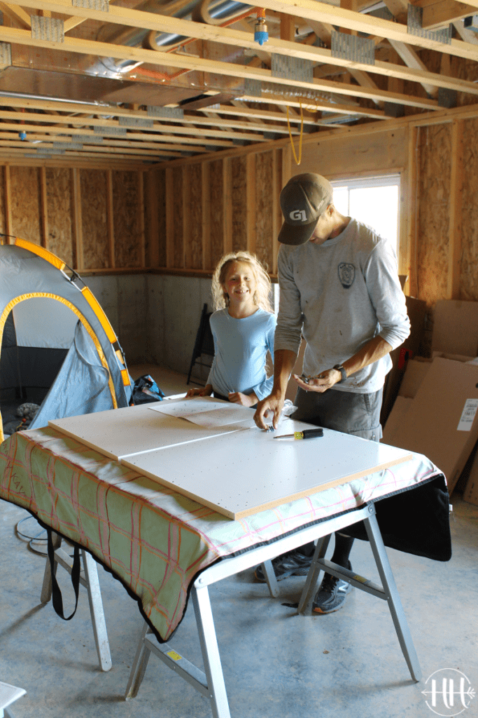 Father and daughter assembling kitchen cabinets.