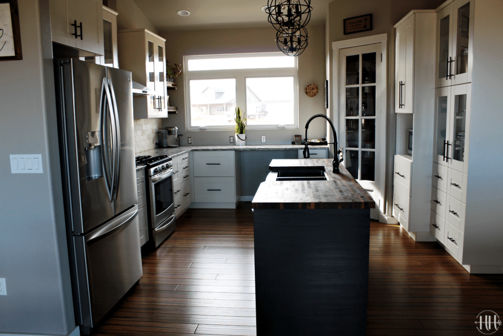 Sammi Ricke's complete view of her white IKEA Sektion kitchen cabinets and black Tingsryd wood island.