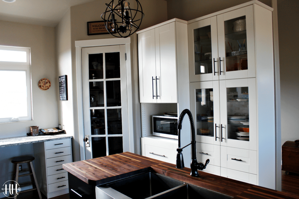 Corner pantry and IKEA cabinets with microwave cabinet and glass GRIMSLOV doors.