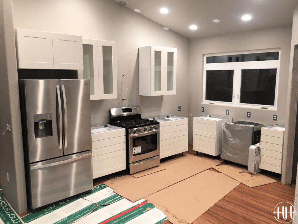 Photo taken at night of cabinets hung in new kitchen.