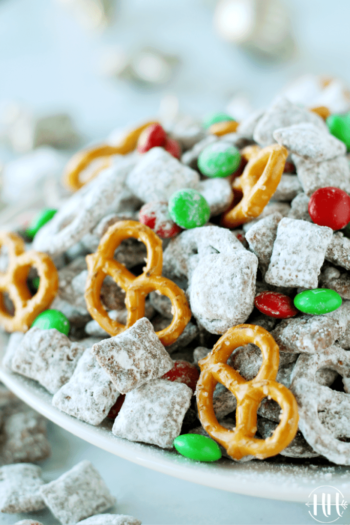 Allergy Friendly Reindeer Chow | This classic Christmas recipe is easy and perfect to give as a gift in a mason jar, set out at a holiday party as a snack, or leave for Santa. Use nut free Sunbutter, gluten free and soy free pretzels and Chex cereal, and dairy free dark chocolate chips in this Muddy Buddies Mix. Kids LOVE this dessert especially with pretzels and red & green M&Ms. Christmas treats that are allergy friendly for kids are hard to come by and this one is delicious and only takes minutes to prepare!