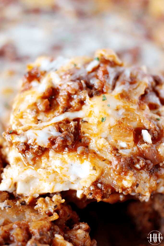 Up close photograph of an ooey gooey piece of homemade meat lasagna.