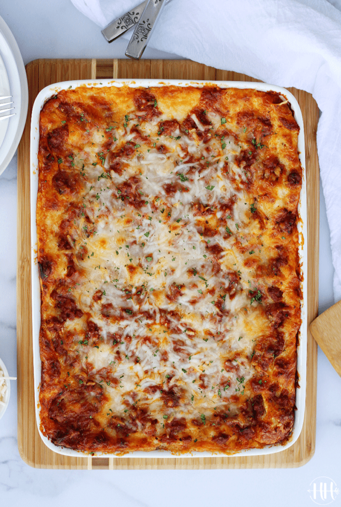 Overhead shot of a rectangular pan of oven baked lasagna ready to be eaten.