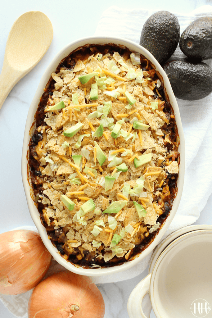 Birds eye view of an easy beef enchilada casserole in an oblong white baking dish.