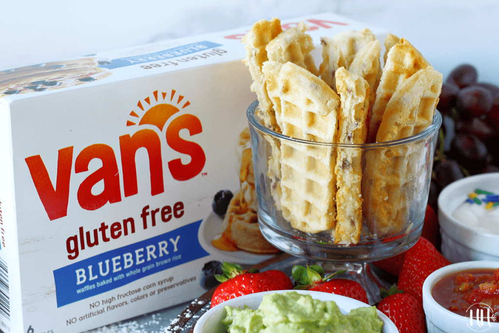 Gluten free blueberry waffles cut into dippers next to their box. 