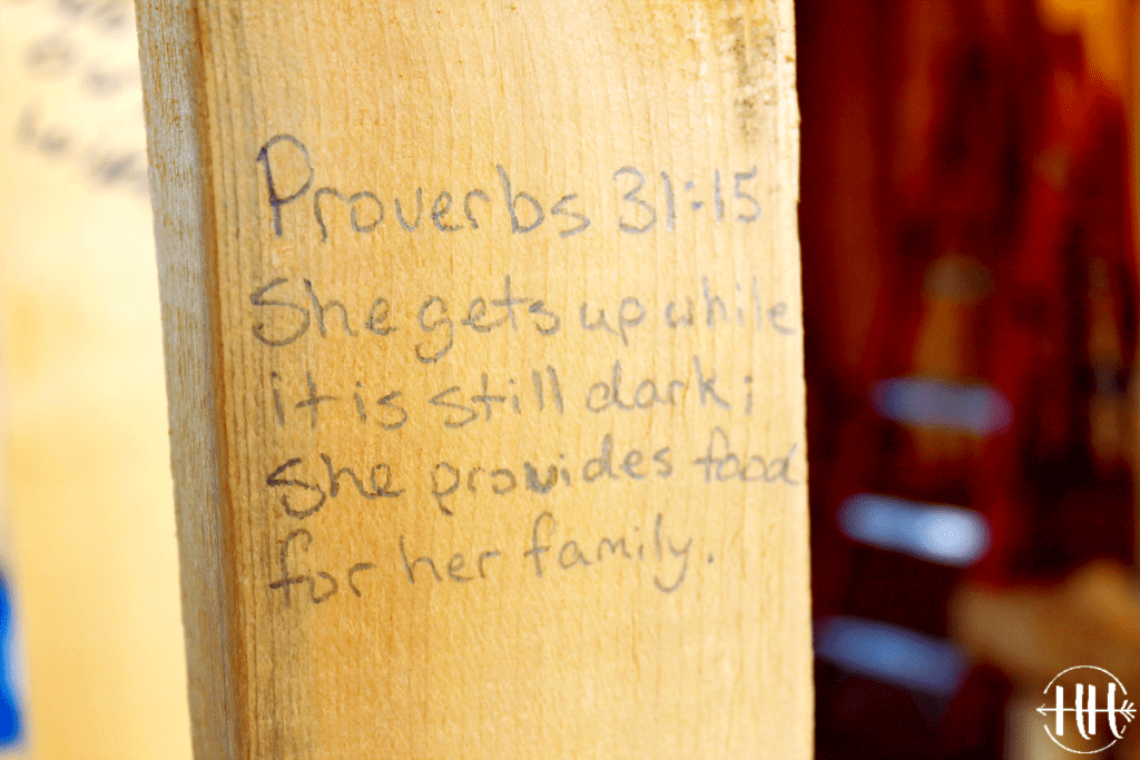 Proverbs 31:15 "She gets up while it is still dark; she provides food for her family" is written on a board in a new kitchen. Bible Verses for a New Home is a way to bring God into your new place of residence. 