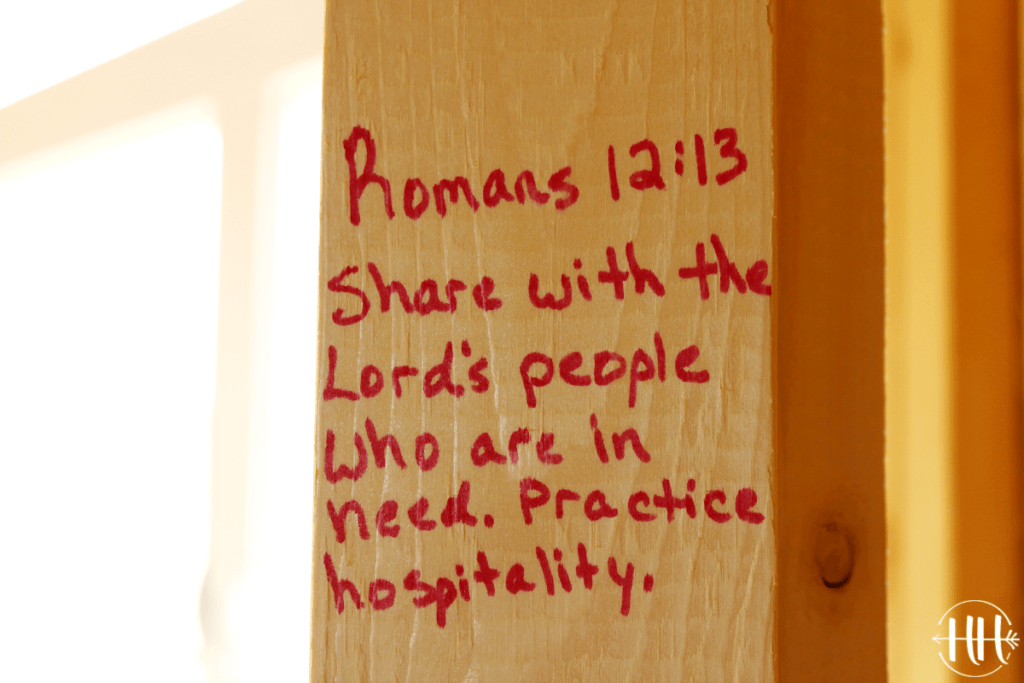 Bible verses for a new home on a 2x4 lumber board.