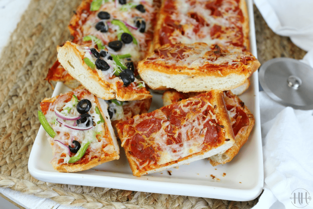 Supreme pizza toppings and pepperoni pizza toppings on top of garlic bread pizza crust.