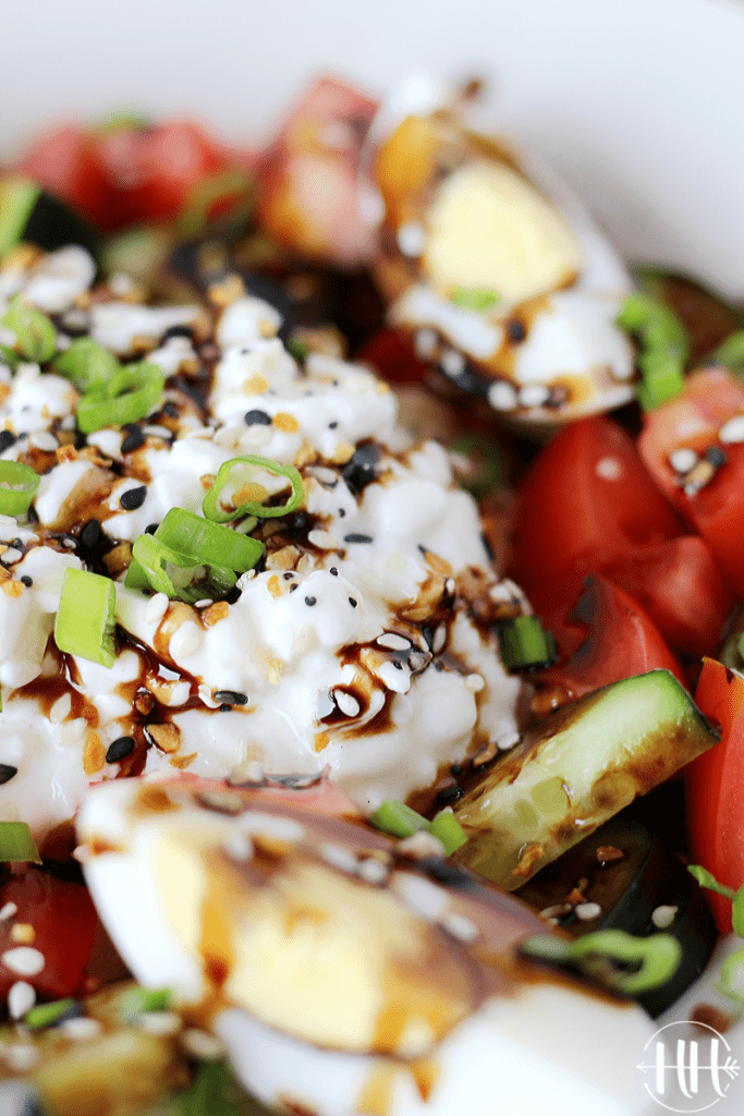 Cottage cheese drizzled with balsamic glaze and topped with green onion.