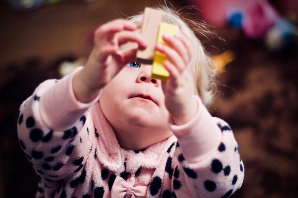 Toddler girl playing with blocks. 