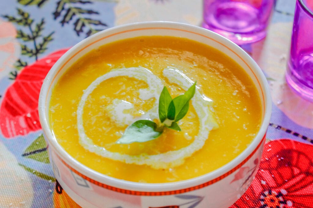 Bright and healthy Butternut Squash Soup swirled with cream. 