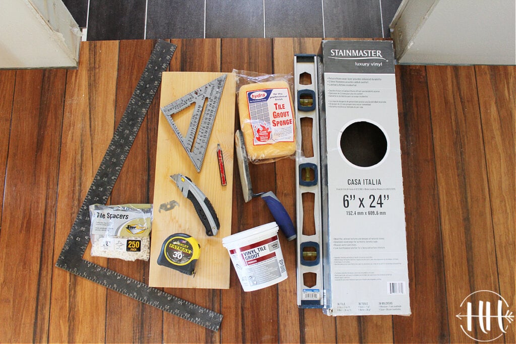 All the tools needed to install luxury vinyl planks including a level, square, and knife.