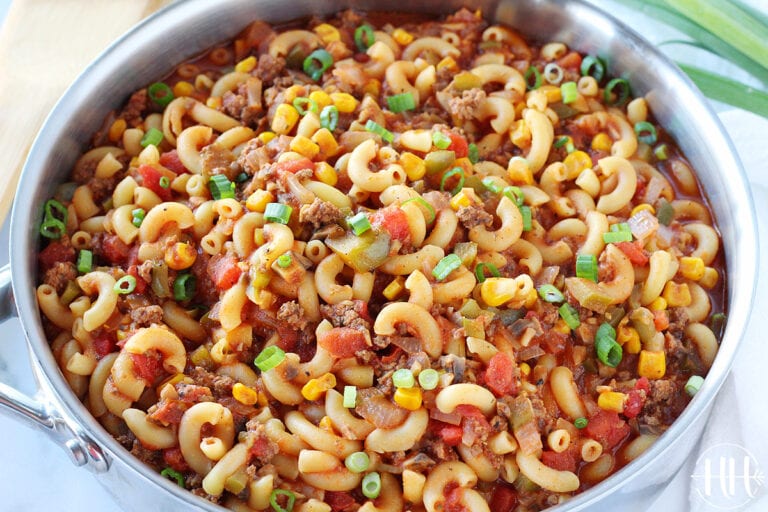 Up close photo of healthy goulash in a pan garnished with green onions.