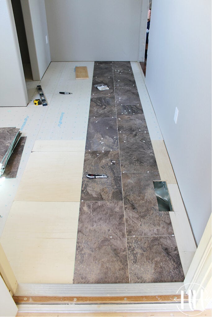 The first two rows of Luxury Vinyl Plank Tile Flooring in a mud room. 