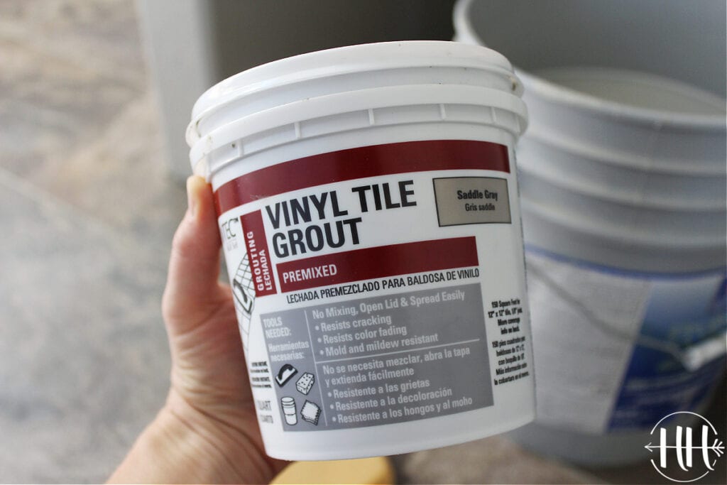 A container of Saddle Grey vinyl tile grout.