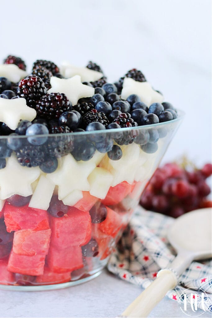 Gorgeous red, white & blue fruit salad in a clear glass bowl.