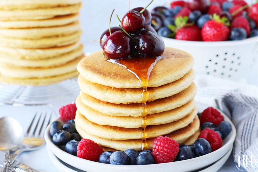 Beautiful stack of pancakes with maple syrup drizzle.