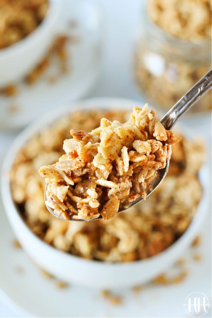 Up close photo of a spoonful of homemade granola and almond milk.