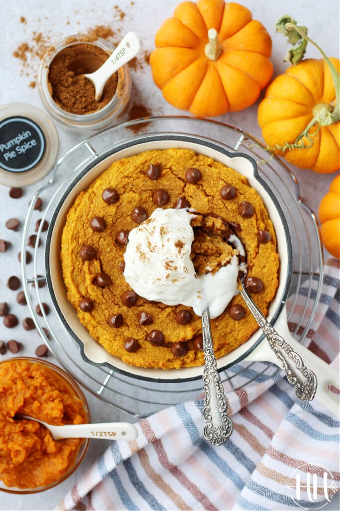 Gorgeous gluten free cake flavored with pumpkin pie spice. Two spoons digging into the healthy single serving recipe. 