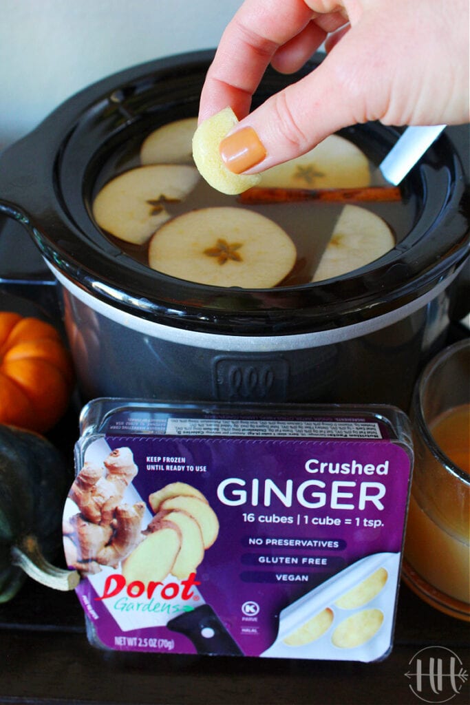 Mulled apple cider in a crockpot with a Dorot Gardens crushed ginger cube added for flavor and health.