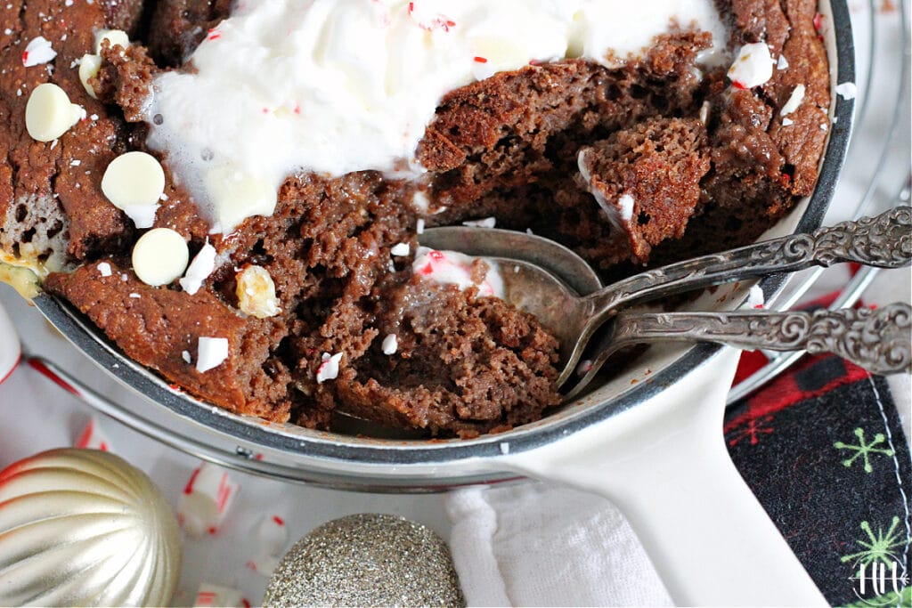 Spoons digging into a healthy holiday skillet cake.