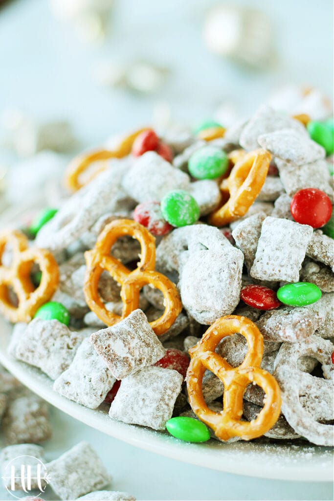 Allergy Friendly Reindeer Chow | This classic Christmas recipe is easy and perfect to give as a gift in a mason jar, set out at a holiday party as a snack, or leave for Santa. Use nut free Sunbutter, gluten free and soy free pretzels and Chex cereal, and dairy free dark chocolate chips in this Muddy Buddies Mix. Kids LOVE this dessert especially with pretzels and red & green M&Ms. Christmas treats that are allergy friendly for kids are hard to come by and this one is delicious and only takes minutes to prepare!