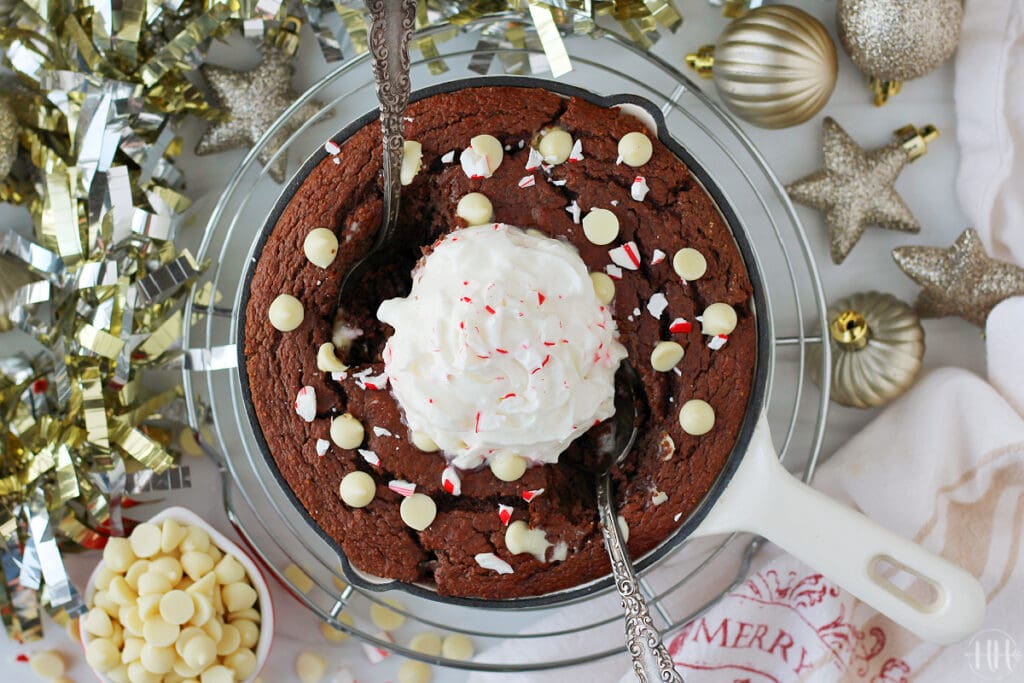 Chocolate peppermint protein cake for one in a white enameled cast iron skillet.