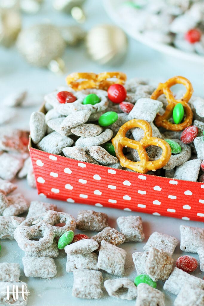 Allergy Friendly Reindeer Chow | This classic Christmas recipe is easy and perfect to give as a gift in a mason jar, set out at a holiday party as a snack, or leave for Santa. Use nut free Sunbutter, gluten free and soy free pretzels and Chex cereal, and dairy free dark chocolate chips in this Muddy Buddies Mix. Kids LOVE this dessert especially with pretzels and red & green M&Ms. Christmas treats that are allergy friendly for kids are hard to come by and this one is delicious and only takes minutes to prepare!