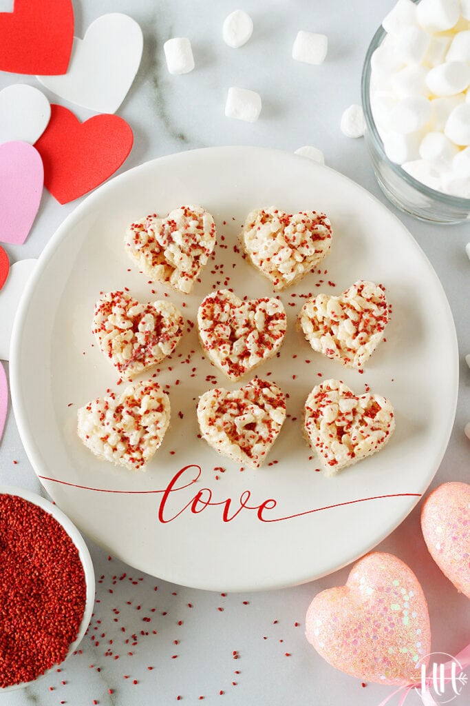 A love plate filled with heart shaped rice krispies topped with cranberry seeds.