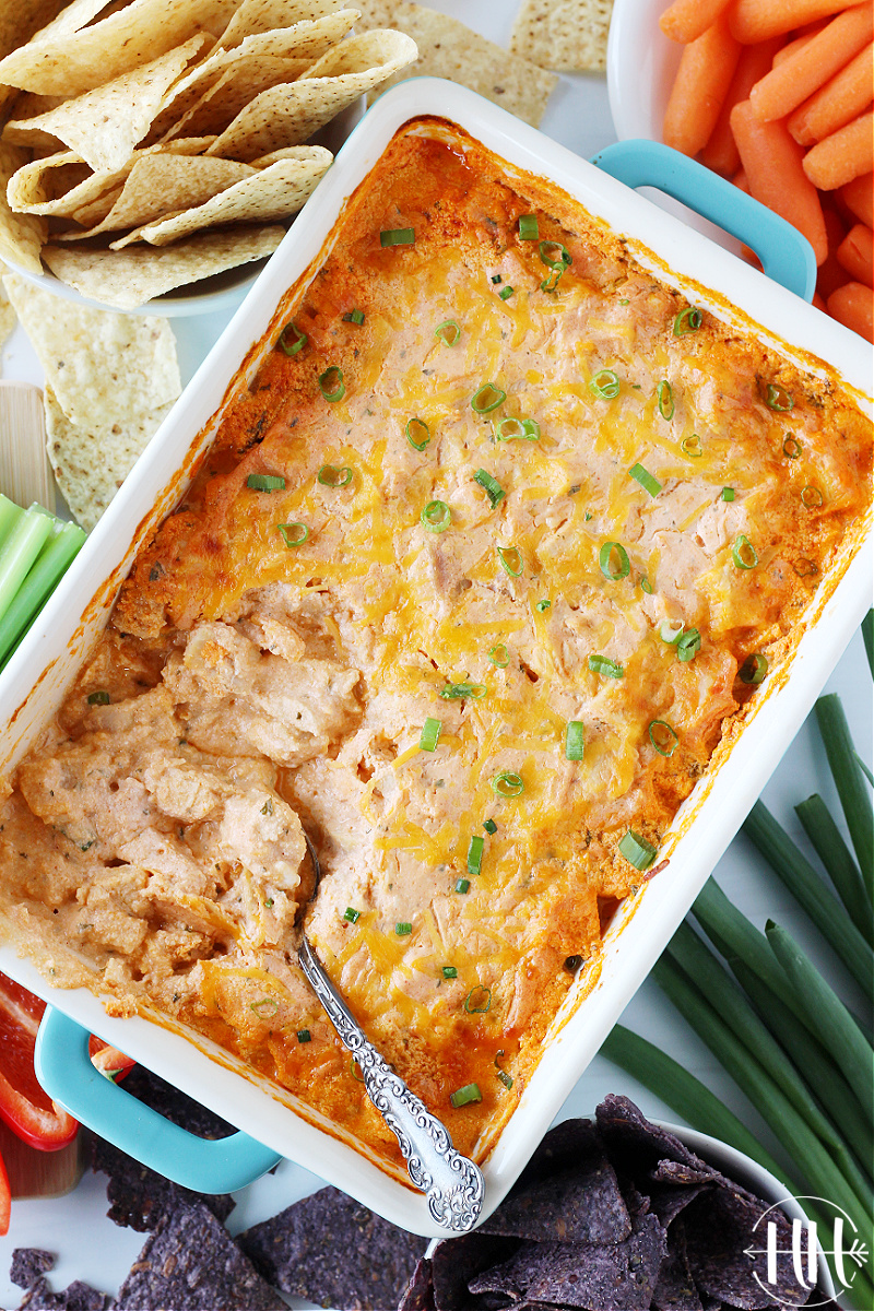 Overhead photo of healthy buffalo chicken dip with a spoon in the pan.