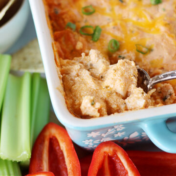 A spoon in a pan of healthy high protein buffalo chicken dip.