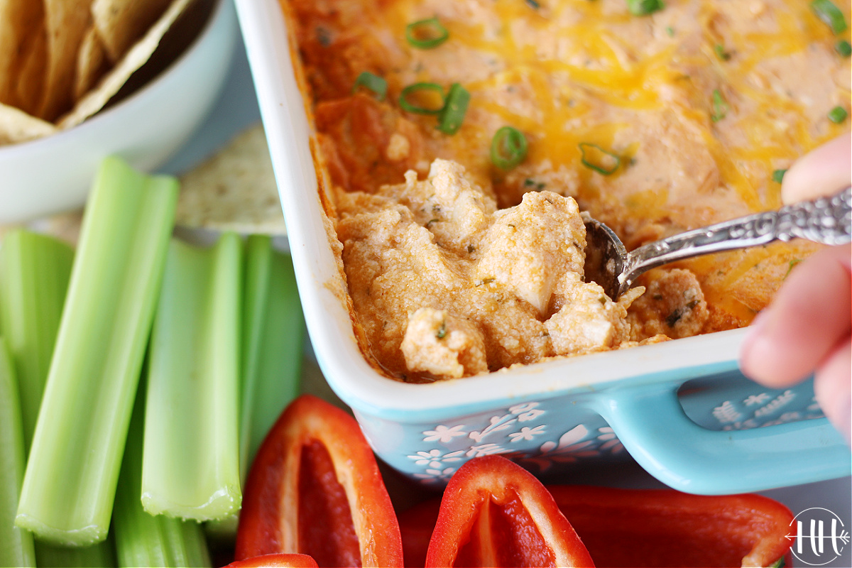 A spoon in a pan of healthy high protein buffalo chicken dip.