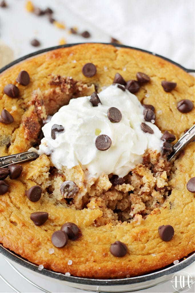 Up close photo of two spoons digging into dairy free protein cake for one. 