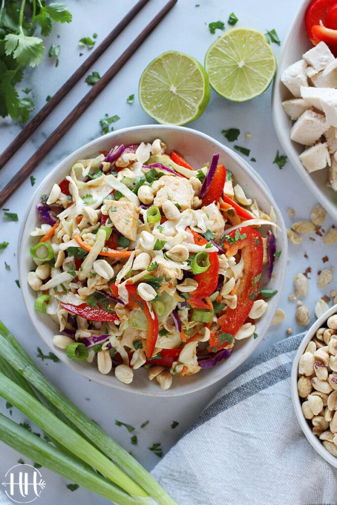 Colorful Asian salad with chopped chicken and peanuts