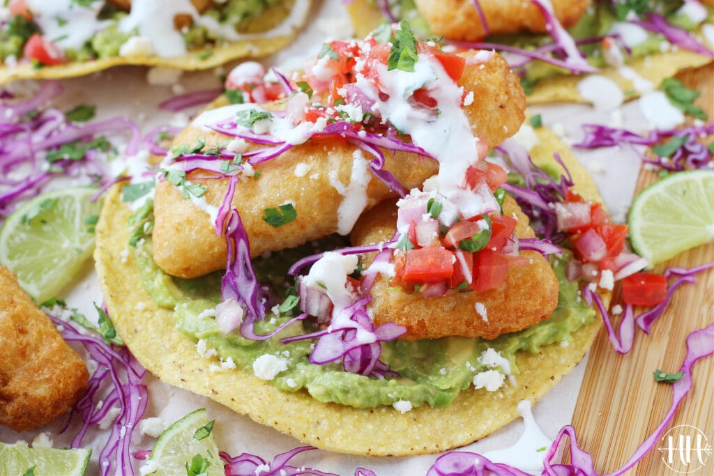 Up close shot of a healthy fish tostada topped with lime crema!